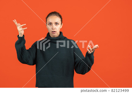 One caucasian young beautiful girl posing isolated on red studio background. One caucasian young beautiful girl posing isolated on red studio background. 82123499