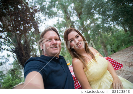 Happy husband and wife taking selfie 82123848