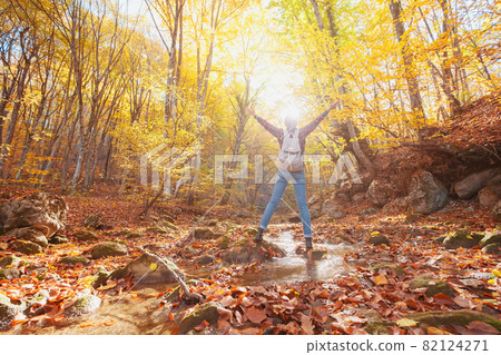 Woman hiking looking at scenic view of autumn foliage landscape. Woman hiking looking at scenic view of autumn foliage landscape. 82124271