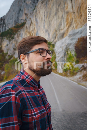 Travel man with backpack hiking in the mountains Travel man with backpack hiking in the mountains 82124304