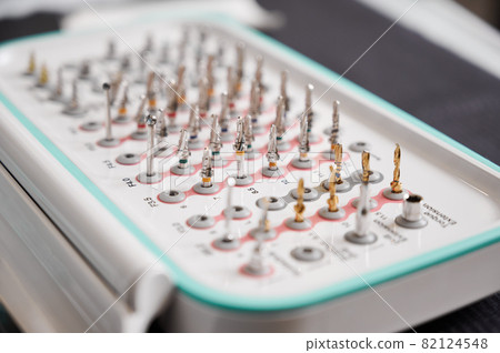 Set of drill nozzles for a dental bur machine for implants. Surgical taper kit. Macro, close up. Concept of contemporary dental technologies 82124548