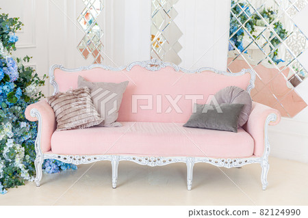 Beautiful luxury classic clean interior living room in white color with pink sofa flower composition. Bright modern stylish interior living room with furniture in classic minimalist style. Beautiful luxury classic clean interior living room in white color with pink sofa flower composition. Bright modern stylish interior living room with furniture in classic minimalist style. 82124990