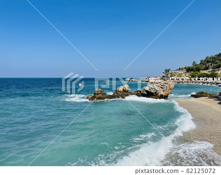 Rocky beach and crystal turquoise water of Ionian Sea in Albania. 82125072