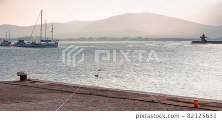 yachts and boats in port of sozopol, bulgaria. beautiful travel landscape with mountains on the sea shore in evening light yachts and boats in port of sozopol, bulgaria. beautiful travel landscape with mountains on the sea shore in evening light 82125631