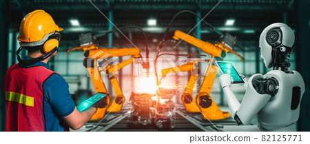 Mechanized industry robot and human worker working together in future factory Mechanized industry robot and human worker working together in future factory 82125771