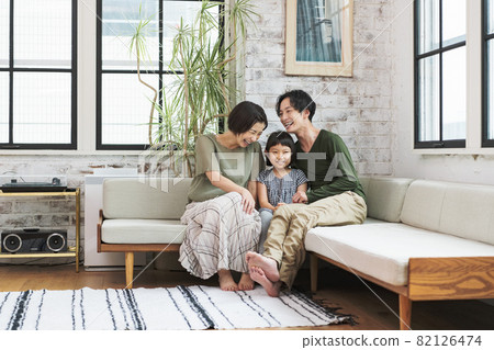 Family chatting happily on the sofa at home 82126474