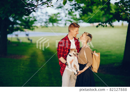 happy couple with dog in Chicago park happy couple with dog in Chicago park 82127888