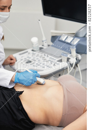 Baking pan with uncooked beef roulades and fresh vegetable trimmings ready for cooking on a white background 82128257