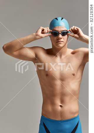 Baking pan with uncooked beef roulades and fresh vegetable trimmings ready for cooking on a white background 82128364