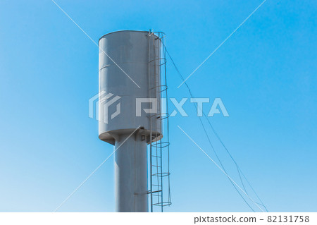 Water tower water storage tank at a height against the blue sky Water tower water storage tank at a height against the blue sky 82131758