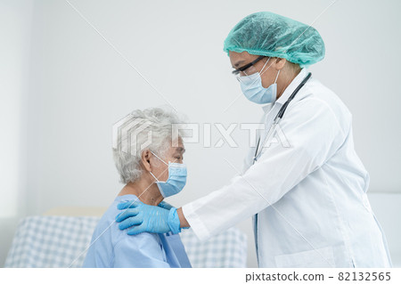 Doctor help Asian senior or elderly old lady woman patient wearing a face mask in hospital for protect safety infection and kill Covid-19 Coronavirus. Doctor help Asian senior or elderly old lady woman patient wearing a face mask in hospital for protect safety infection and kill Covid-19 Coronavirus. 82132565