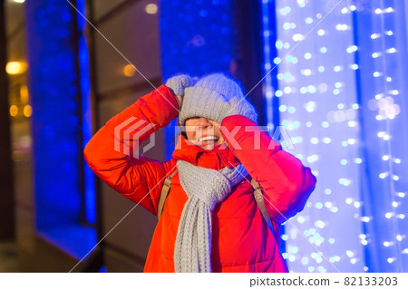 Girl in a night city snowflake Christmas city lights. Christmas and winter holidays concept. 82133203