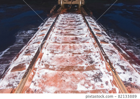 The remains of white ammonium nitrate, fertilizers when unloading a wagon on railway tracks The remains of white ammonium nitrate, fertilizers when unloading a wagon on railway tracks 82133889