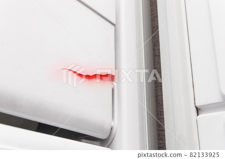 Crack on the polystyrene lid of the refrigerator freezer, close-up. The need to repair the refrigerator 82133925