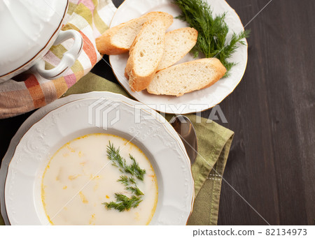 Creamy fish soup with salmon, potatoes, onions and carrots 82134973