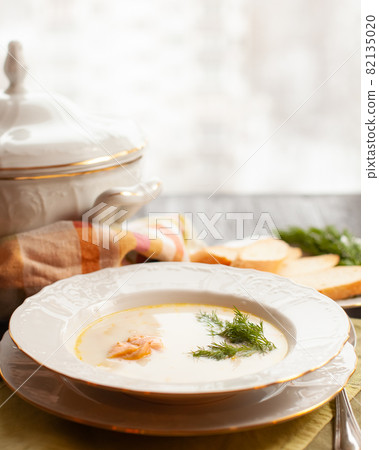 Creamy fish soup with salmon, potatoes and dill Creamy fish soup with salmon, potatoes and dill 82135020