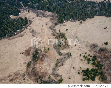 A dirt road a mountain A plant  82135575