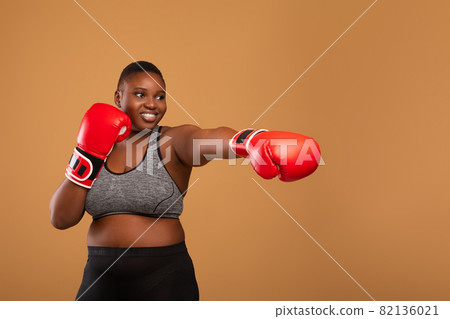 Young Black Woman Boxing Wearing Red Gloves At Studio 82136021