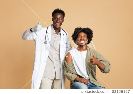 African American Doctor And Male Patient Showing Thumbs Up After Successful Vaccination 82136167