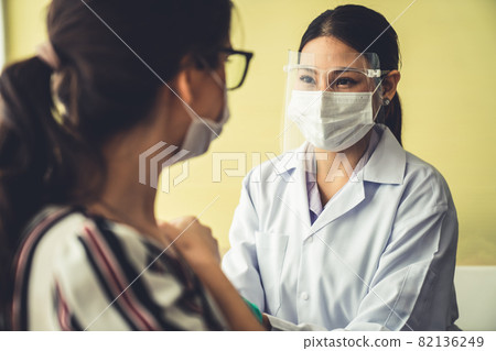 Young woman visits skillful doctor at hospital for vaccination Young woman visits skillful doctor at hospital for vaccination 82136249