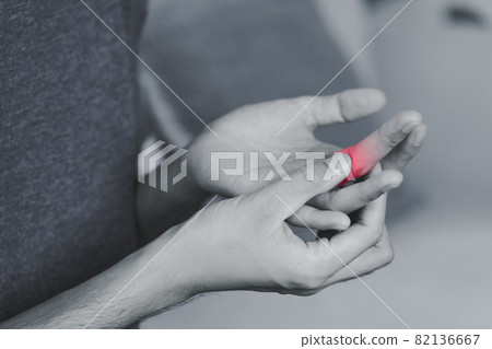 Man suffering from hand and finger joint pain with red highlight. rheumatoid arthritis, carpal tunnel syndrome, gout. Health care and medical concept. 82136667
