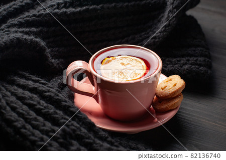 Mug with tea and lemon on black background 82136740