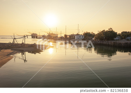Nice panoramic view of fishing huts at sunrise near Ravenna 82136838