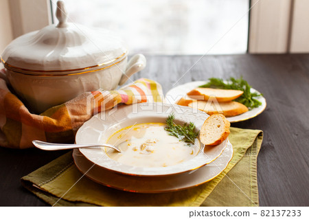 Creamy fish soup with salmon, potatoes and dill Creamy fish soup with salmon, potatoes and dill 82137233