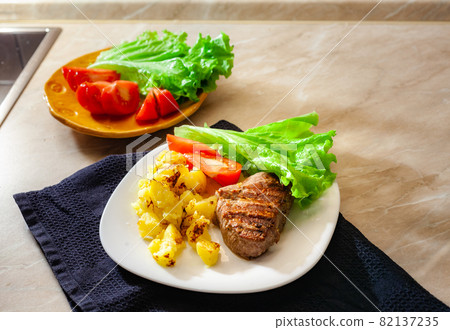 Hot steak on a dish with fried potates Hot steak on a dish with fried potates 82137235