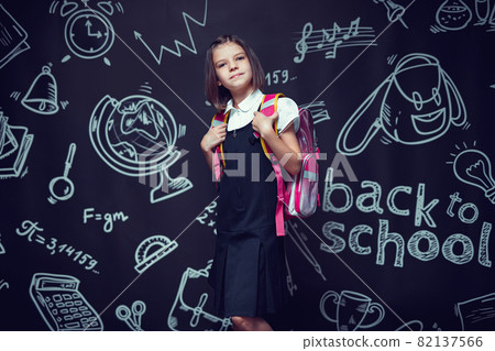 caucasian pre-teen schoolgirl preparing to go to school with backpack. Back to school concept caucasian pre-teen schoolgirl preparing to go to school with backpack. Back to school concept 82137566