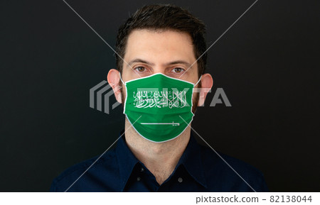 Man wearing Saudi Arabian flag protective medical face mask. 82138044