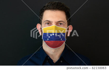 Man wearing Venezuelan flag protective medical face mask. Man wearing Venezuelan flag protective medical face mask. 82138063