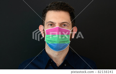 Man wearing a LGBT polysexual flag colors protective face mask. 82138141