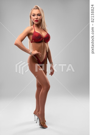 Competing woman in red lingerie and high heels Competing woman in red lingerie and high heels 82138824