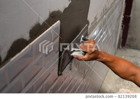 House renovation, Laying ceramic tiles on the wall. 82139208