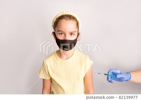 A nurse is giving vaccinations to patients with a syringe. White background. Close-up shot of injection against covid19. A nurse is giving vaccinations to patients with a syringe. White background. Close-up shot of injection against covid19. 82139977