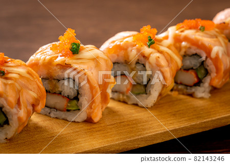 grilled salmon sushi roll with sauce 82143246