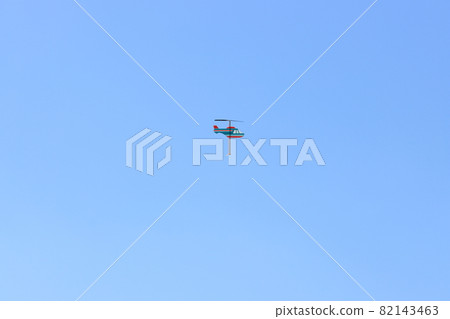 Helicopter toys flying in the blue sky Helicopter toys flying in the blue sky 82143463