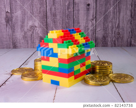 home multicolour toy brick and gold coins for kid or property business concept 82143738