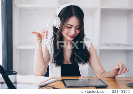 Young undergraduate student studying online class by laptop computer 82145503