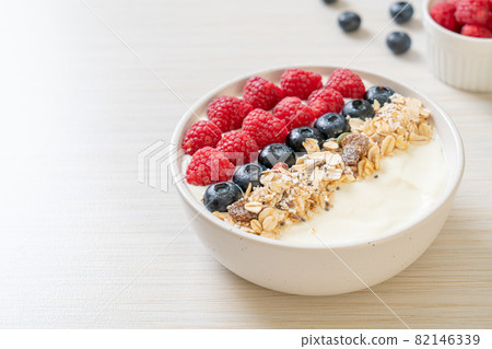 homemade yogurt bowl with raspberry, blueberry and granola 82146339