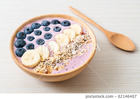 yogurt or yoghurt smoothie bowl with blue berry, banana and granola 82146487