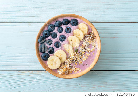 yogurt or yoghurt smoothie bowl with blue berry, banana and granola 82146489