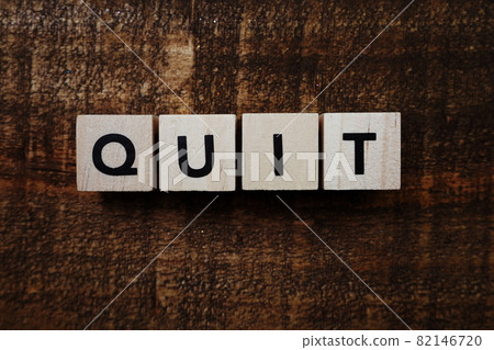 Quit alphabet letter on wooden background 82146720