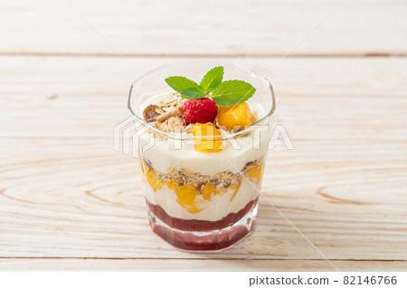 homemade mango and raspberry with yogurt and granola 82146766