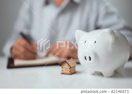 Concept of save, investment, Financial planning. Piggy bank with man doing finances and calculate on desk at home office. Concept of save, investment, Financial planning. Piggy bank with man doing finances and calculate on desk at home office. 82146873