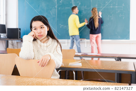 Portrait of unhappy female chinese student in auditorium 82147327