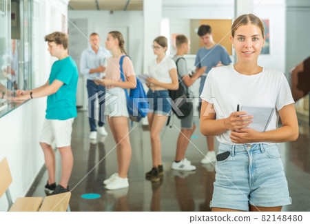 Teenager girl standing in hallway 82148480