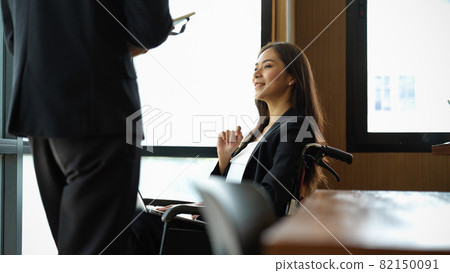 Attractive asian disabled businesswoman in wheelchair Attractive asian disabled businesswoman in wheelchair 82150091