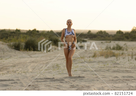Young woman in stylish colorful swimwear on beach Young woman in stylish colorful swimwear on beach 82151724